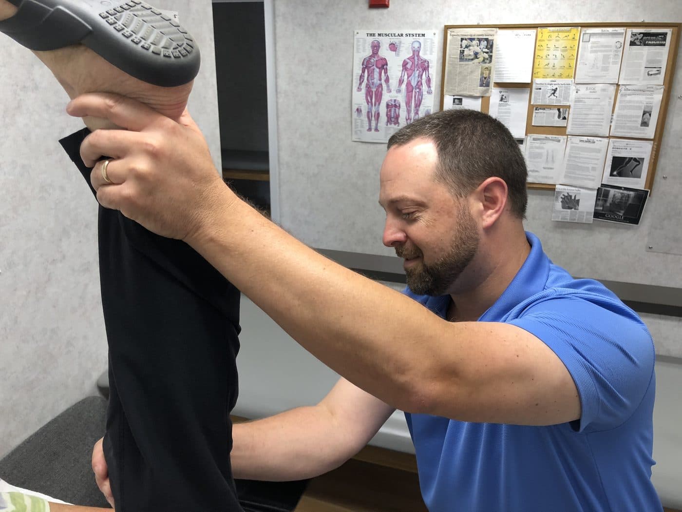 Therapist stretching a patient's leg at Northport Wellness PT